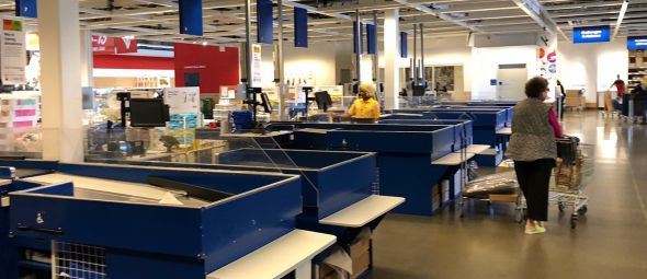 Interior of cashier's check and furniture showcase, large IKEA store with a wide range of products.