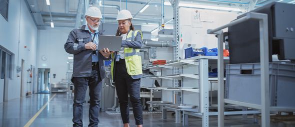 Portrait of Two Heavy Industry Employees in Hard Hats at Factory