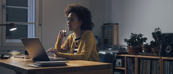 African American woman Using Laptop Computer at Night