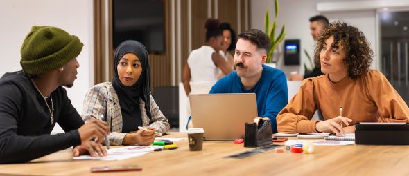 Workers talking at common coworking space tables